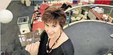  ??  ?? LOOKING BACK: Wendy Langerak holds a picture of herself taken at the opening of Toowoomba City Library on Victoria St in 1988.