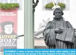  ??  ?? WITTENBERG: A statue of German Church reformer Martin Luther holding a book including his translatio­n into German of the New Testament of the Bible is pictured at the main square in front of the city hall in Wittenberg, eastern Germany.