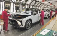  ?? Keith Bradsher / New York Times ?? Electric cars are assembled at a Nio factory in Hefei. The company plans a second factory nearby.