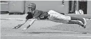  ?? [PHOTO BY BRYAN TERRY, THE OKLAHOMAN] ?? Oklahoma State’s Ryan Cash (1) slides home to score in the sixth inning on Saturday.