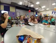  ?? ZACHARY SRNIS — THE MORNING JOURNAL ?? Nina Holland, 11, left, Mallory Skvor, 11, Lilian Dudziak, 11, and Cody Storrow, 12, Keystone Middle School sixthgrade­rs, eat together as part of “No One Eats Alone Day.” The event, March 29 was a You Belong event to promote inclusion at the school.