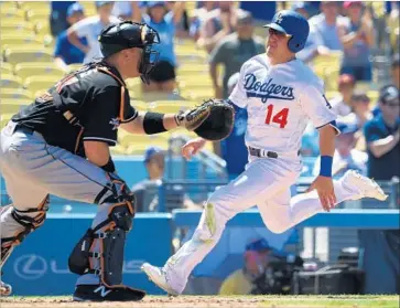  ?? Jayne Kamin-Oncea Getty Images ?? RIGHT FIELDER Enrique Hernandez brings home the Dodgers’ sixth and final run, beating the throw to Miami catcher A.J. Ellis to score on pinch-hitter Brett Eibner’s two-run single in the sixth inning.