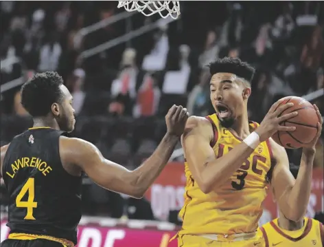  ?? ASSOCIATED PRESS ?? (right) grabs a rebound away form Arizona State forward Kimani Lawrence during the first half of a game on Wednesday in Los Angeles.