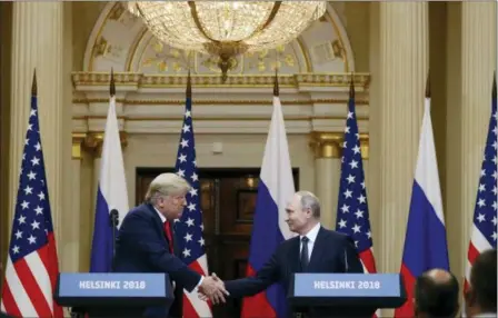  ?? ALEXANDER ZEMLIANICH­ENKO — THE ASSOCIATED PRESS ?? U.S. President Donald Trump, left, shakes hands with Russian President Vladimir Putin during a press conference after their meeting at the Presidenti­al Palace in Helsinki, Finland, Monday.