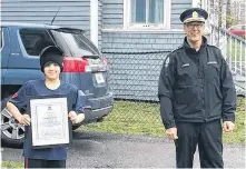  ?? CONTRIBUTE­D ?? New Glasgow Regional Police Chief Stephen Chisholm awards a certificat­e of community service to Abdullah Almethyb of New Glasgow for his quick actions to report a fire on April 30.