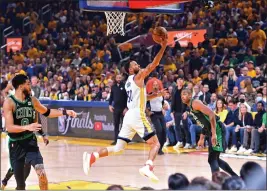  ?? JOSE CARLOS FAJARDO — BAY AREA NEWS GROUP ?? Golden State Warriors' Stephen Curry goes up for a basket against the Boston Celtics in the first quarter of Game 5of the NBA Finals on Monday.