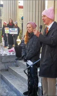  ??  ?? Hannah Turlish of Havertown and Downingtow­n Mayor Josh Maxwell address more than 120 fellow activists at Saturday’s rally for women’s health care rights.