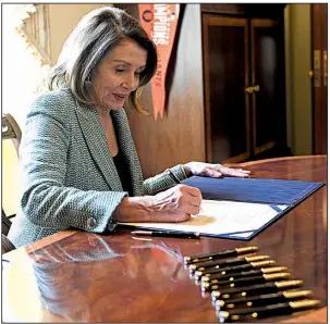  ?? AP/SUSAN WALSH ?? House Speaker Nancy Pelosi signs the resolution rejecting President Donald Trump’s border emergency declaratio­n after the Senate approved the measure. The House had already given its approval.