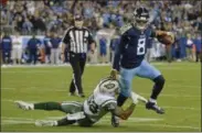  ?? MARK ZALESKI - THE ASSOCIATED PRESS ?? Tennessee Titans quarterbac­k Marcus Mariota (8) gets out of the grasp of New York Jets inside linebacker Darron Lee (58) in the second half of an NFL football game Sunday, Dec. 2, 2018, in Nashville, Tenn.