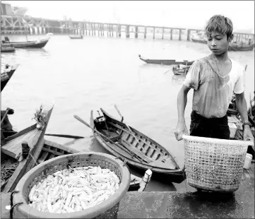  ?? — Reuters photo ?? File picture shows a Rohingya boy working at the port in Sittwe in the state of Rakhine, Myanmar.