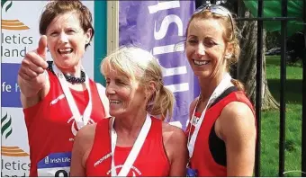  ??  ?? Deirdre McFerran, Nuala Reilly and Karen Delaney react after being presented with their bronze medals at the National Road Relays in Raheny.