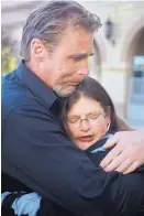  ?? GREG SORBER/JOURNAL ?? The parents of Sean Markey, Sean Markey and Tricia Ruger, hug outside 2nd Judicial District Court on Tuesday.