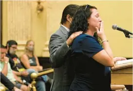  ?? KENNETH K. LAM/BALTIMORE SUN ?? Rachel Butrim, the widow of Baltimore City Fire Department Lt. Paul Butrim, holds back tears during her testimony Tuesday.