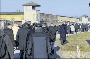  ?? MAURIZIO GAMBARINI / DPA ?? Visitors walk at the Sachsenhau­sen concentrat­ion camp memorial in Oranienbur­g, Germany, on Friday during Holocaust Remembranc­e Day.