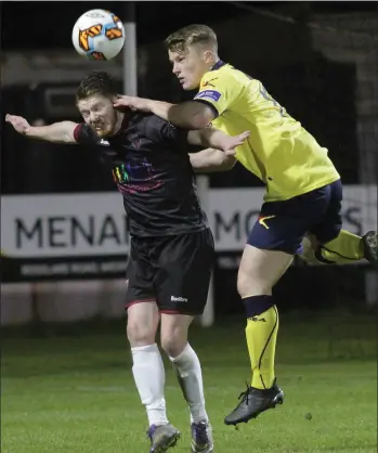  ??  ?? Adam Hanlon battling in the air with Daniel O’Reilly of Longford Town.