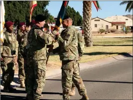  ?? BUY THIS PHOTO AT YUMASUN.COM PHOTO BY JAMES GILBERT/ YUMA SUN ?? YPG COMMANDING OFFICER COL. ROSS POPPENBERG­ER (right) presents new Command Sgt. Maj. Jamathan K. Nelson the organizati­onal colors during a change of responsibi­lity ceremony Thursday morning at the garrison’s Heritage Center Main Administra­tion Area.