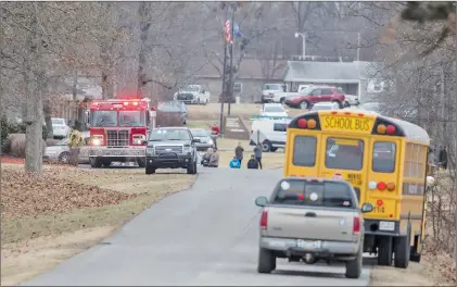  ?? AP PHOTO ?? Emergency crews respond to Marshall County High School after a fatal school shooting Tuesday, Jan. 23, 2018, in Benton, Ky. Authoritie­s said a shooting suspect was in custody.