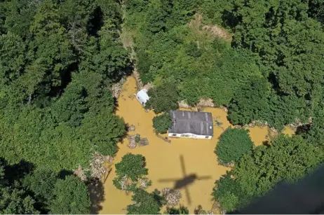  ?? (AFP) ?? Floodwater surrounds a house as the Kentucky National Guard fly a recon and rescue mission on Saturday in Breathitt County near Jackson, Kentucky