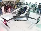  ??  ?? The Ehang 184 autonomous aerial vehicle, a self-flying passenger drone that resembles a small helicopter was also shown to the audience