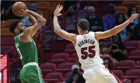  ?? AP ?? GETTING HIS SHOTS: Jayson Tatum shoots over Miami’s Duncan Robinson on Friday night in Miami.