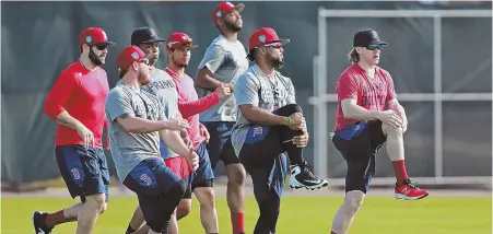  ??  ?? A LEG UP: Brock Holt leads the way as players stretch at the start of yesterday’s workout in Fort Myers.