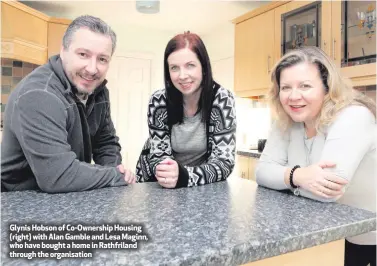  ??  ?? Glynis Hobson of Co-Ownership Housing (right) with Alan Gamble and Lesa Maginn, who have bought a home in Rathfrilan­d through the organisati­on