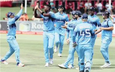  ?? | BackpagePi­x ?? LUNGI Ngidi of the Titans celebrates with his teammates after claiming the wicket of Grant Mokoena of the Knights during their Momentum One-Day Cup match at SuperSport Park yesterday.