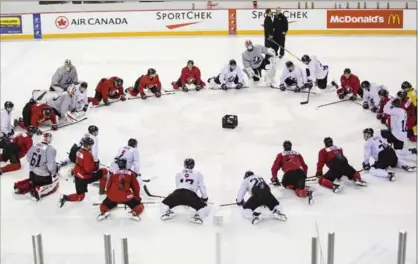 ?? AARON LYNETT, THE CANADIAN PRESS ?? Canadian national junior team prospects gather at centre ice on the first day of selection camp in St. Catharines on Tuesday.