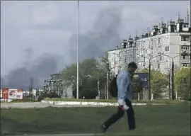  ?? ?? SMOKE RISES from the site of a Russian attack in Kharkiv. Many other parts of Ukraine have maintained a relative sense of normality amid air-raid sirens.