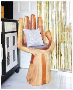  ??  ?? ‘I bought this beautiful wooden hand from Birkacre Garden Centre. It goes with the wooden doors in the kitchen. I put up the glittery curtain from Amazon for a surprise party and just kept it up’