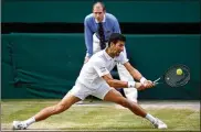  ?? GETTY IMAGES MATTHIAS HANGST / ?? Novak Djokovic of Serbia plays a backhand in his Men’s Singles final against Roger Federer of Switzerlan­d during The Championsh­ips - Wimbledon 2019