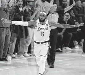  ?? Mark J. Terrill/associated Press ?? Lakers forward Lebron James joins the frenzied arena in celebratin­g the basket Tuesday that pushed him past Kareem Abdul-jabbar on the NBA scoring list.