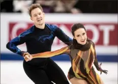  ?? Getty Images ?? Ice dancers Madison Chock, right, and Evan Bates won their first world championsh­ip Saturday.
