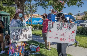  ?? Bobby Block/The Signal ?? A small group of protesters gathers at a shopping center near the intersecti­on of Whites Canyon Road and Soledad Canyon Road on Monday afternoon in response to a viral video circulatin­g online depicting SCV Sheriff’s Station deputies detaining three Black teenagers at gunpoint.