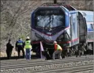  ?? MICHAEL BRYANT/THE PHILADELPH­IA INQUIRER VIA AP, FILE ?? In this April 3, 2016, file photo, Amtrak investigat­ors inspect the deadly train crash in Chester. The Amtrak train struck a piece of constructi­on equipment just south of Philadelph­ia causing a derailment.