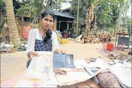  ?? PTI ?? ■ A woman shows her documents that were damaged due to floods in Kerala at Annamanada in Thrissur on Sunday.