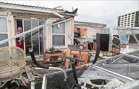  ??  ?? Mighty Matthew: Homeowner Joe Lovece surveying the damage to the kitchen at the back of his oceanfront home after Hurricane Matthew passed Ormond Beach, Florida. — Reuters