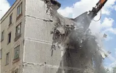  ?? SERGEI ILNITSKY, EUROPEAN PRESSPHOTO AGENCY ?? An excavator demolishes a five-story building in Moscow that was built in the early 1960s on June 20. Moscow city authoritie­s initiated a controvers­ial program to demolish Soviet-era apartment blocks.