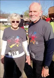  ?? SALLY CARROLL/MCDONALD COUNTY PRESS ?? The Bearbowers, in their mid-70s, don’t take cheers at the finish line lightly. The two have worked hard to compete and successful­ly finished the 5K Saturday morning.