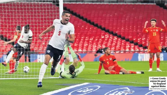  ?? Glyn Kirk/Getty Images ?? > Conor Coady enjoys his goal for England against Wales