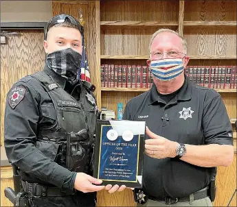  ?? Photograph submitted ?? Police Chief Lynn Hahn, right, presented a plaque to officer Wyatt Varner who was selected Officer of the Year 2020 by his peers.