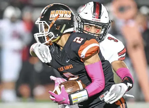  ?? Alexandra Wimley/Post-Gazette ?? Bethel Park’s Jehvonn Lewis is tackled by Peters Township’s Donovan McMillon Friday night at Bethel Park High School.