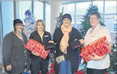  ?? FILE PHOTO ?? With long-time friend Rachel MacLean, left, Tanya Marie Olscamp, third from left, delivers “Overcomer” hats to cancer patient navigator Dianna Hutt, right, and oncology team leader Cathy Hale, second from left, at the Valley Regional Hospital last...