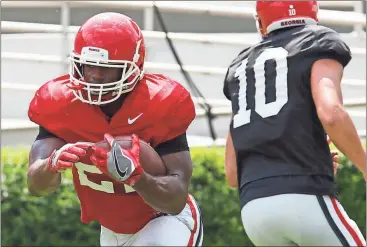  ?? File, Joshua L. Jones / Athens Banner-Herald via AP ?? Georgia tailback Nick Chubb (27) takes a hand off from quarterbac­k Jacob Eason (10) during practice in Athens.