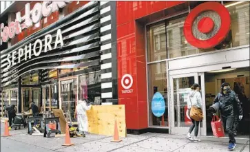  ?? Mary Altaffer Associated Press ?? TARGET, which sells “essential” items, has seen sales rise, even among discretion­ary products, during the pandemic. “Nonessenti­al” companies such as Foot Locker, Macy’s and L Brands are at a big disadvanta­ge.