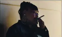  ?? JOSE CARLOS FAJARDO — STAFF PHOTOGRAPH­ER ?? Linda Grant, 51, of Oakland, smokes a joint at her home last week. Grant says she has little role in the dispensary she holds the license to.