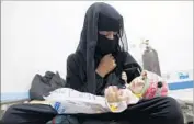  ?? Mohammed Huwais AFP/Getty Images ?? A YEMENI woman seeks treatment for her child, suspected of having cholera, at a hospital in Sana.