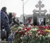  ?? AP ?? Russian opposition leader Alexei Navalny’s mother, Lyudmila Navalnaya (left), and his mother-in-law Alla Abrosimova visit his grave Saturday in Moscow.