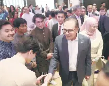  ?? — Bernama photo ?? Anwar greets Malaysians during a gathering with in Berlin, organised in conjunctio­n with his visit to Germany.