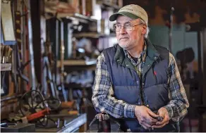  ?? GABRIELA CAMPOS/THE NEW MEXICAN ?? Ward Brinegar, owner of Harmony Forge, stands in his workshop Friday on the first day of sales of hundreds of his tools. Brinegar has been blacksmith­ing for 42 years and will now retire to travel cross-county in a camper.